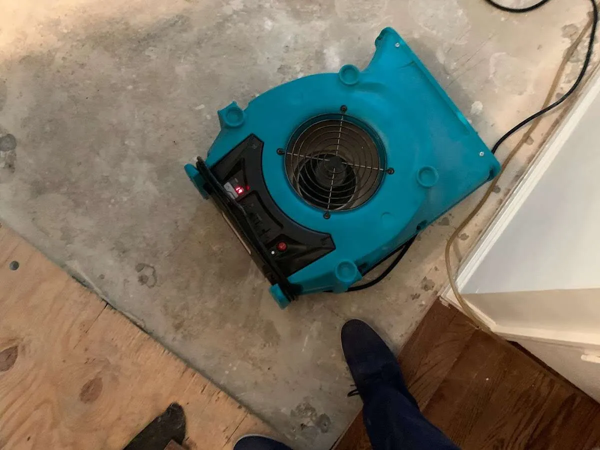 Air mover drying subfloor during Commercial Water Damage Restoration in Providence Village